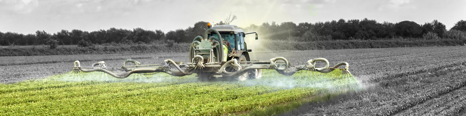 tractor spraying pesticides on a field